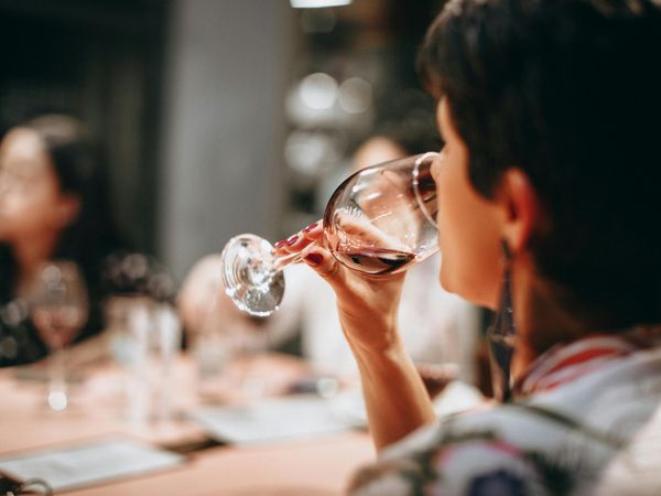 Person enjoying a glass of rosé wine during a tasting experience in Buenos Aires.