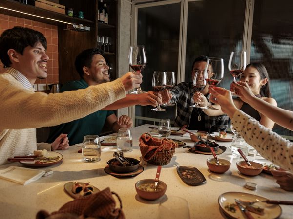 Friends toast with Argentine wine during a traditional dinner in Buenos Aires.