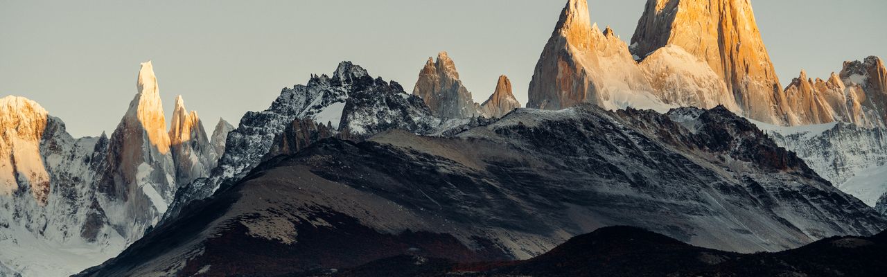 Mount Fitz Roy and Cerro Torre rise dramatically at sunrise in El Chaltén, Argentine Patagonia