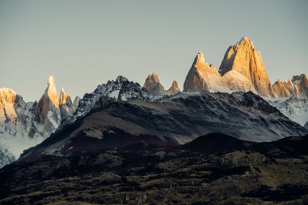 Mount Fitz Roy and Cerro Torre rise dramatically at sunrise in El Chaltén, Argentine Patagonia