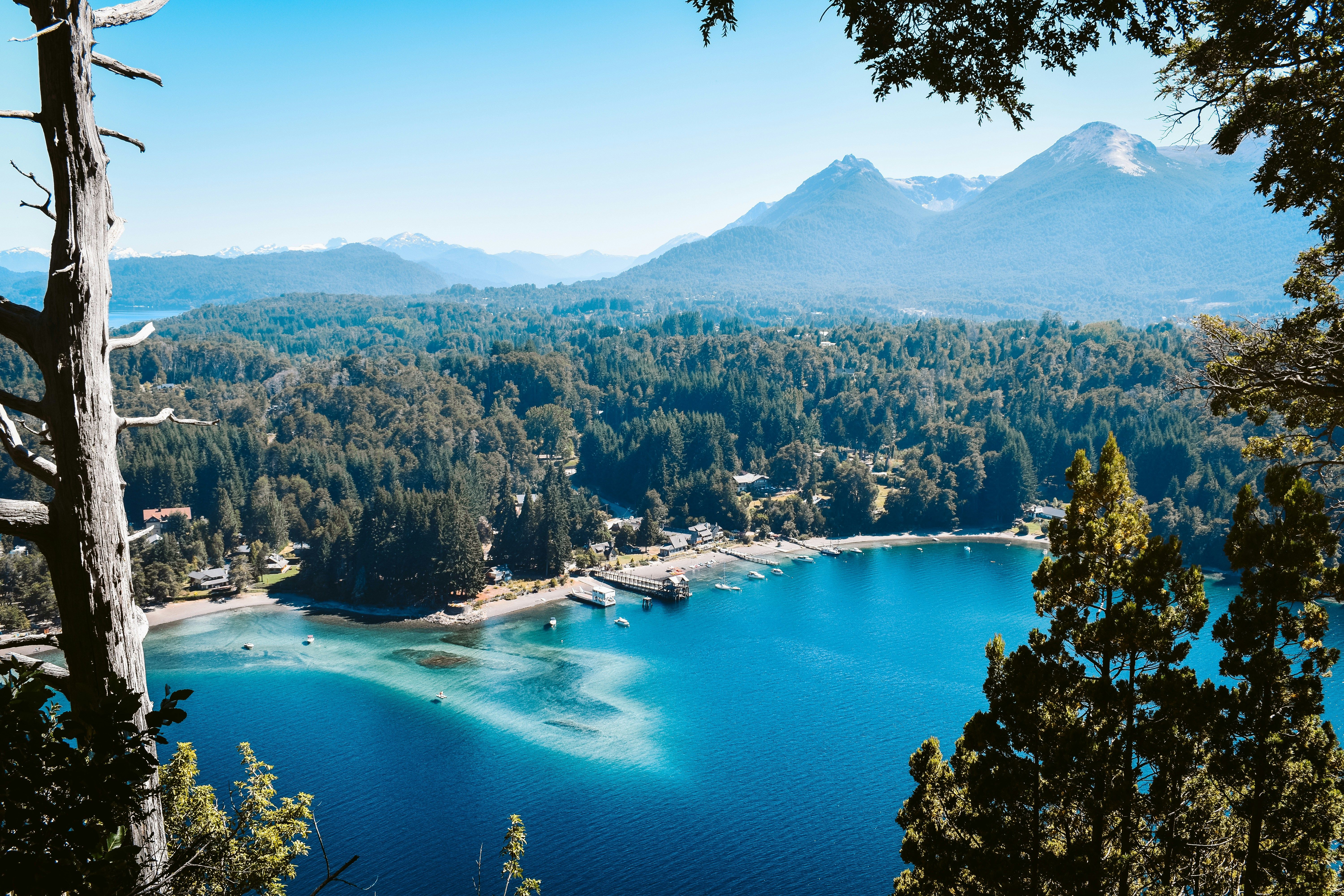 Turquoise waters of Lago Nahuel Huapi with snow-capped Andes mountains near Villa La Angostura, Bariloche