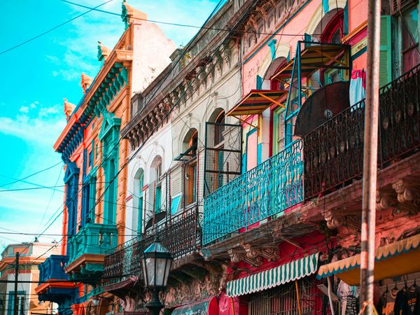 Colorful colonial architecture with ornate balconies and vibrant facades in La Boca, Buenos Aires.