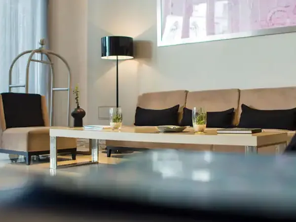 Modern luxury hotel lobby in Buenos Aires Recoleta with beige seating, contemporary furnishings, and minimalist décor.
