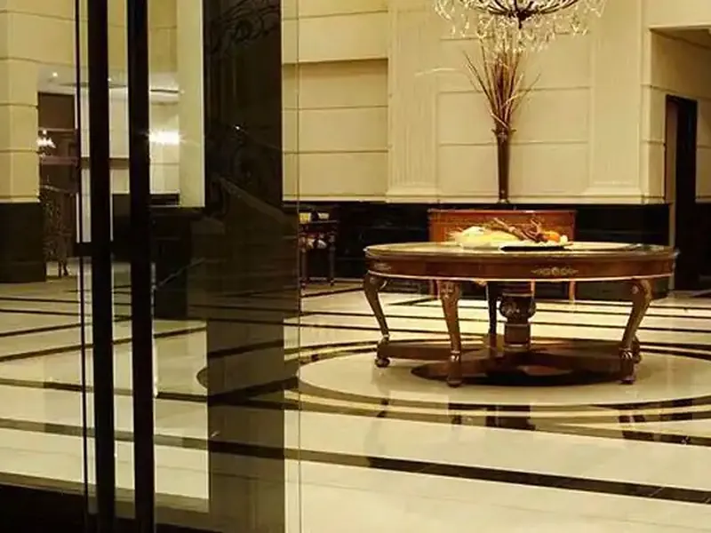 Elegant diplomatic reception hall with polished marble floors, ornate round table, and classical architecture in Buenos Aires.