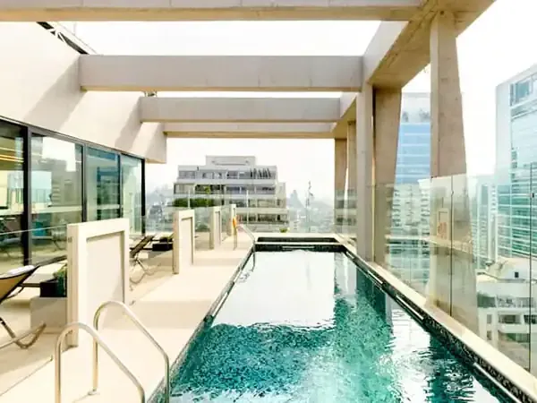 Luxury rooftop lap pool with city views at Hyatt Centric Santiago, featuring modern architecture and urban skyline.
