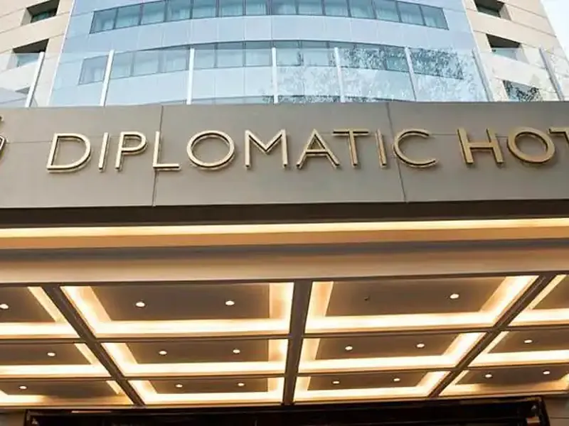 Diplomatic Hotel entrance with illuminated canopy and modern building facade in Buenos Aires.
