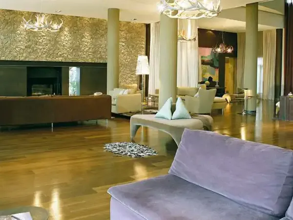 Luxurious modern hotel lobby with polished wood floors, contemporary furniture, and elegant ambient lighting in a Patagonia resort.