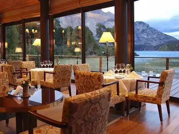 Elegant dining room at Llao Llao Hotel overlooking Nahuel Huapi Lake and Patagonian mountains in Bariloche.
