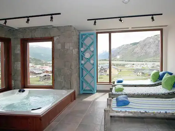 Modern spa with hot tub, yoga mats, and panoramic mountain valley views at Los Cerros Boutique Hotel in Patagonia.