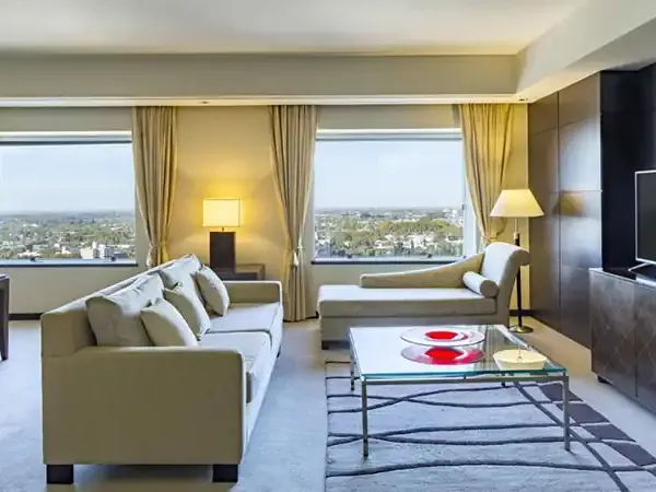 Luxury hotel suite in Mendoza with modern furnishings, panoramic city views, and elegant décor overlooking the Argentine wine region.