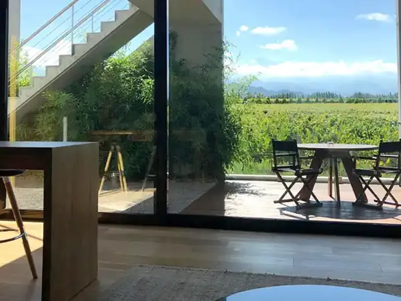 Modern winery interior with panoramic vineyard views across the Uco Valley, Mendoza, Argentina.