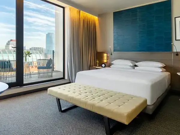 Modern hotel room at Hyatt Centric Santiago with city skyline views, contemporary furnishings, and floor-to-ceiling windows overlooking downtown.