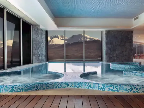 Luxury indoor pool with mountain views at Arakur Resort in Ushuaia, Patagonia.