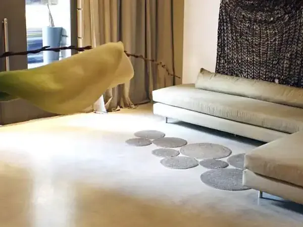 Luxury hotel suite with modern white sofas, yellow accent pieces, and elegant décor at Esplendor in Patagonia.