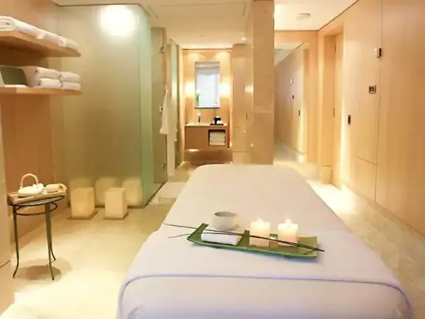 Modern spa treatment room at Park Hyatt with massage table, ambient lighting, and serene wellness ambiance.
