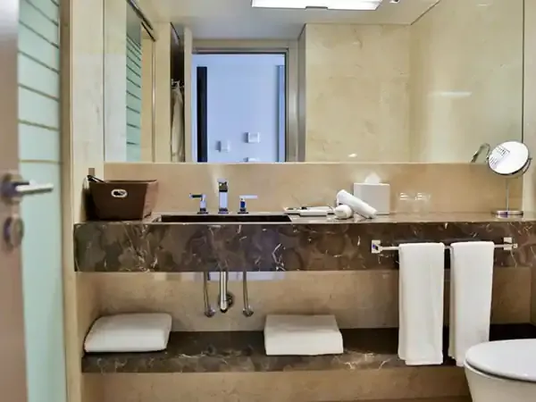 Modern luxury bathroom at Palladio Hotel with marble countertop, dual vanity, and contemporary amenities.