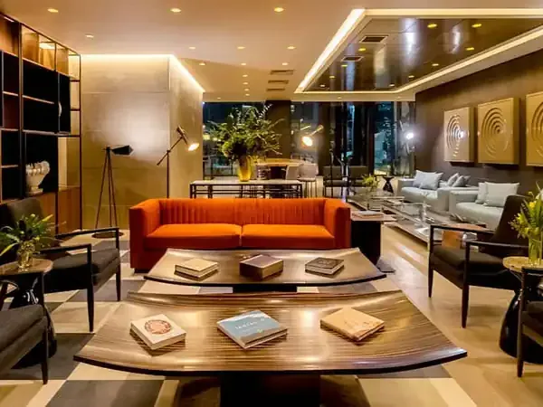 Luxurious modern lobby at Hyatt Centric Santiago featuring bold orange sofa, warm lighting, and contemporary design.