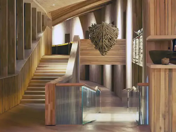 Modern wooden staircase and corridor at Hotel Tierra Patagonia with natural light and contemporary design elements.