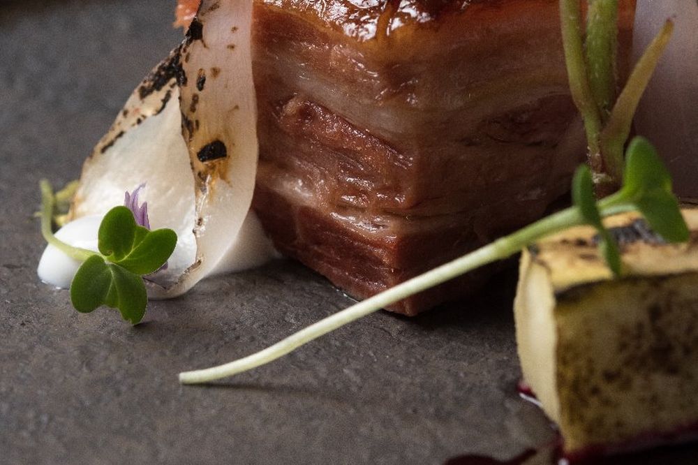 Artfully plated chocolate dessert with pear garnish and microgreens at Bariloche fine dining restaurant.