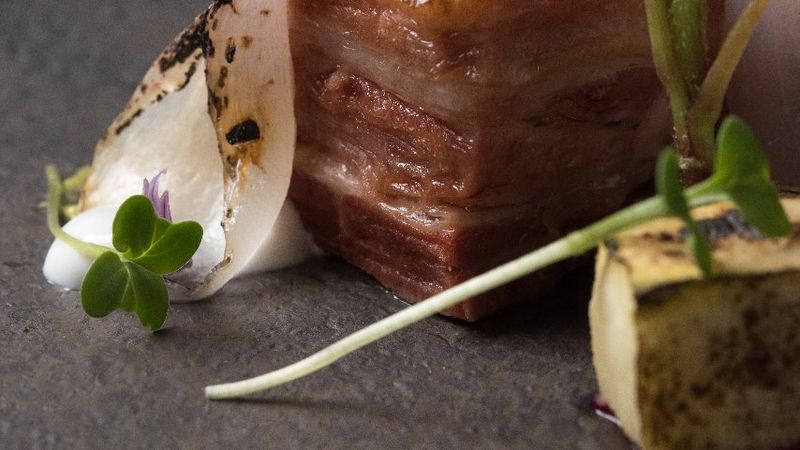 Artfully plated chocolate dessert with pear garnish and microgreens at Bariloche fine dining restaurant.
