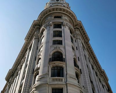 Ornate beaux-arts tower with cylindrical design and classical architectural details in Buenos Aires.