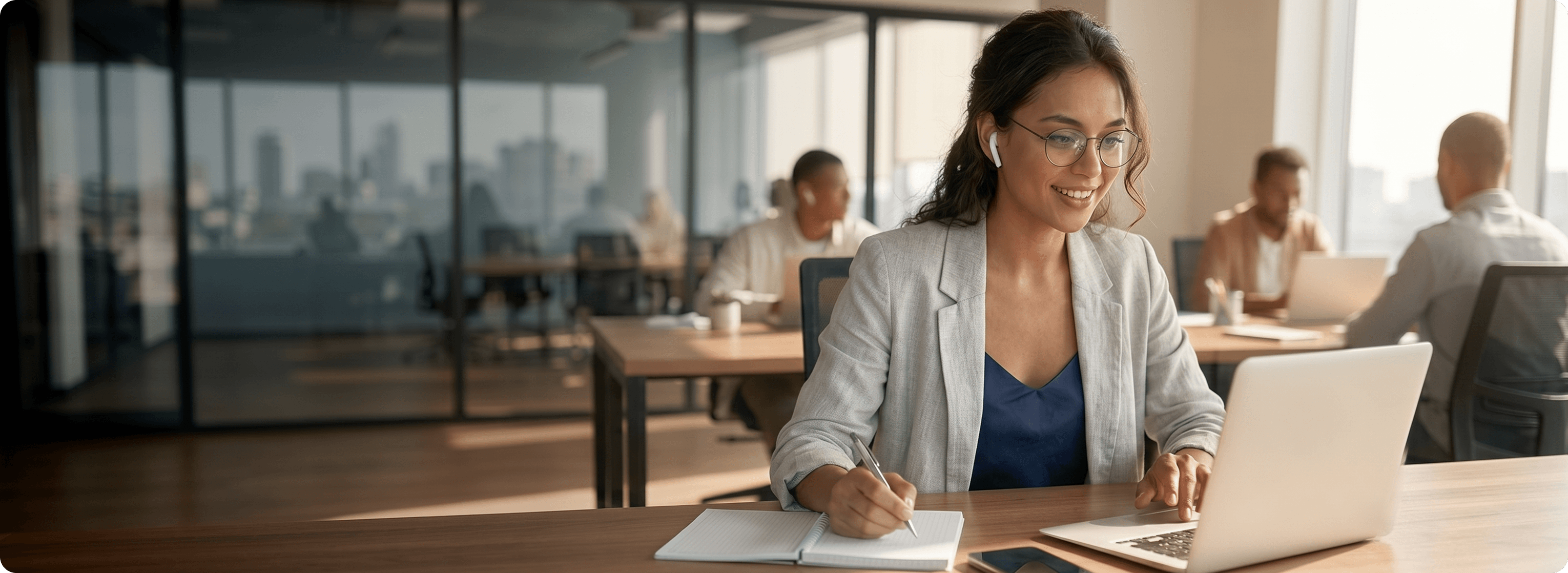 Remote worker taking notes in a sunlit office