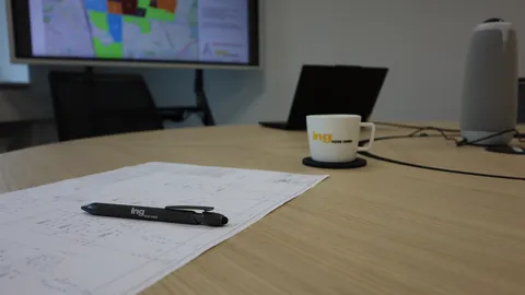 Stift der Firma ing Kess lieg auf einem Plan.