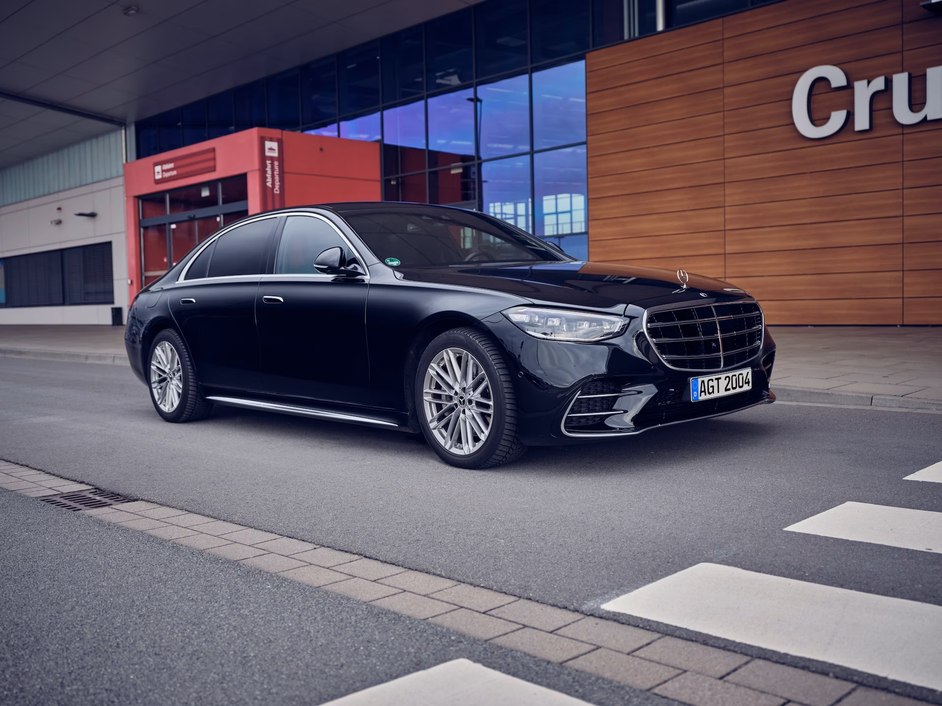 Schwarze Limousine im VIP-Transfer vor dem Cruise Center, bereit für die komfortable Personenbeförderung.