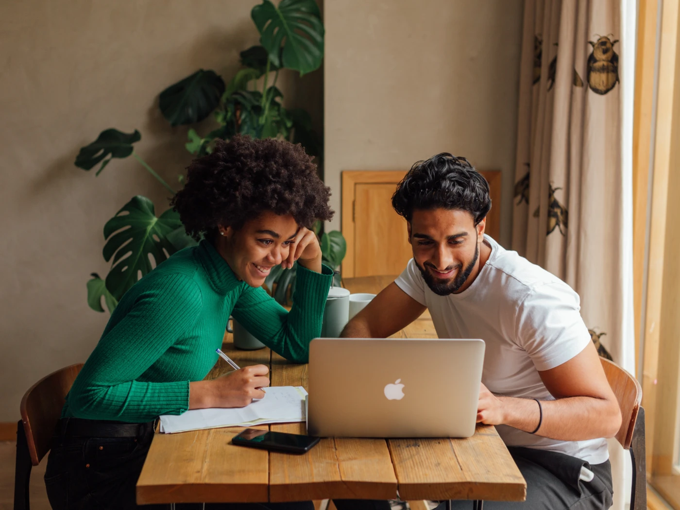 couple booking hotel room together on laptop