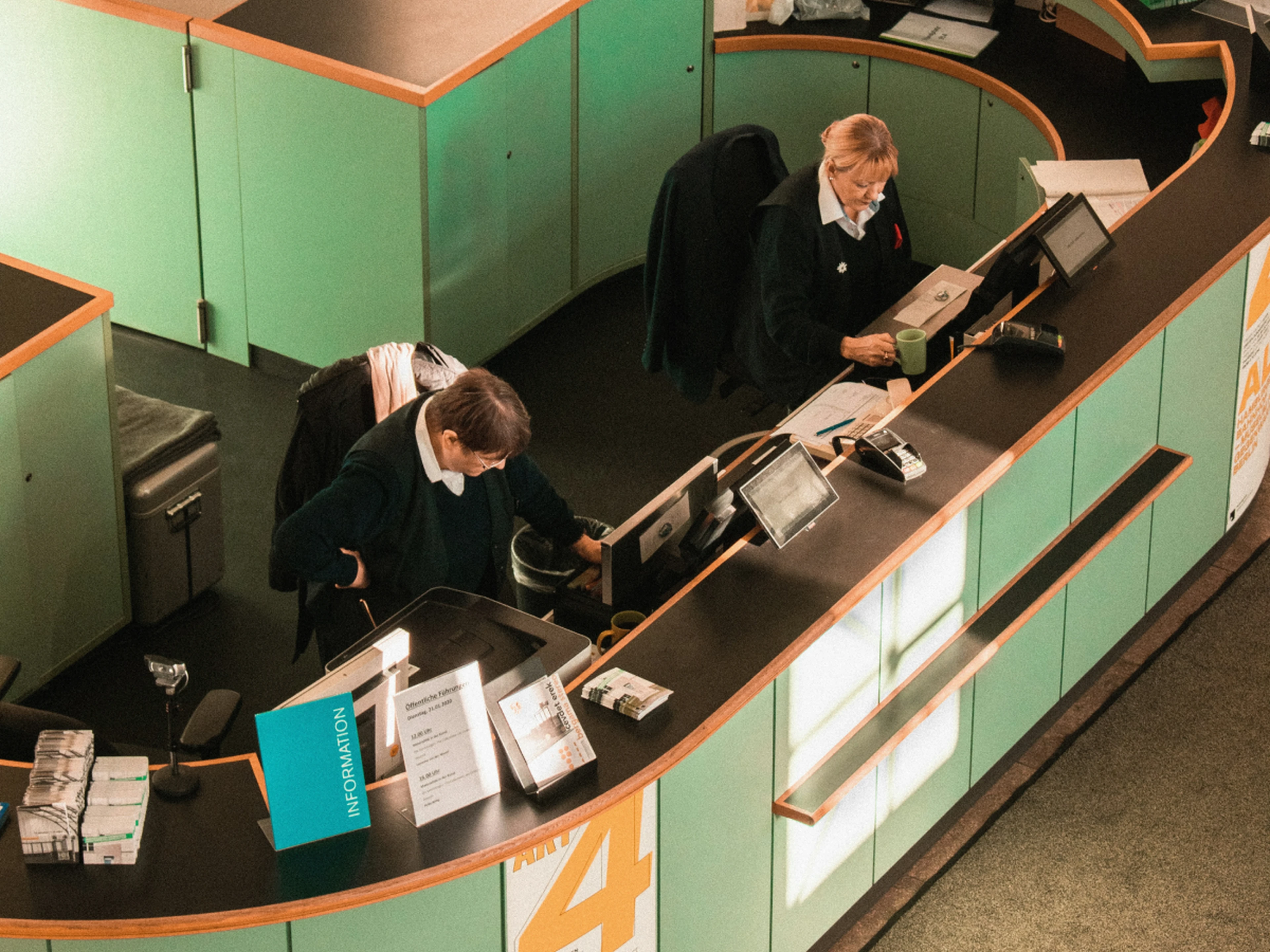 Hotel reception desk with two receptionists