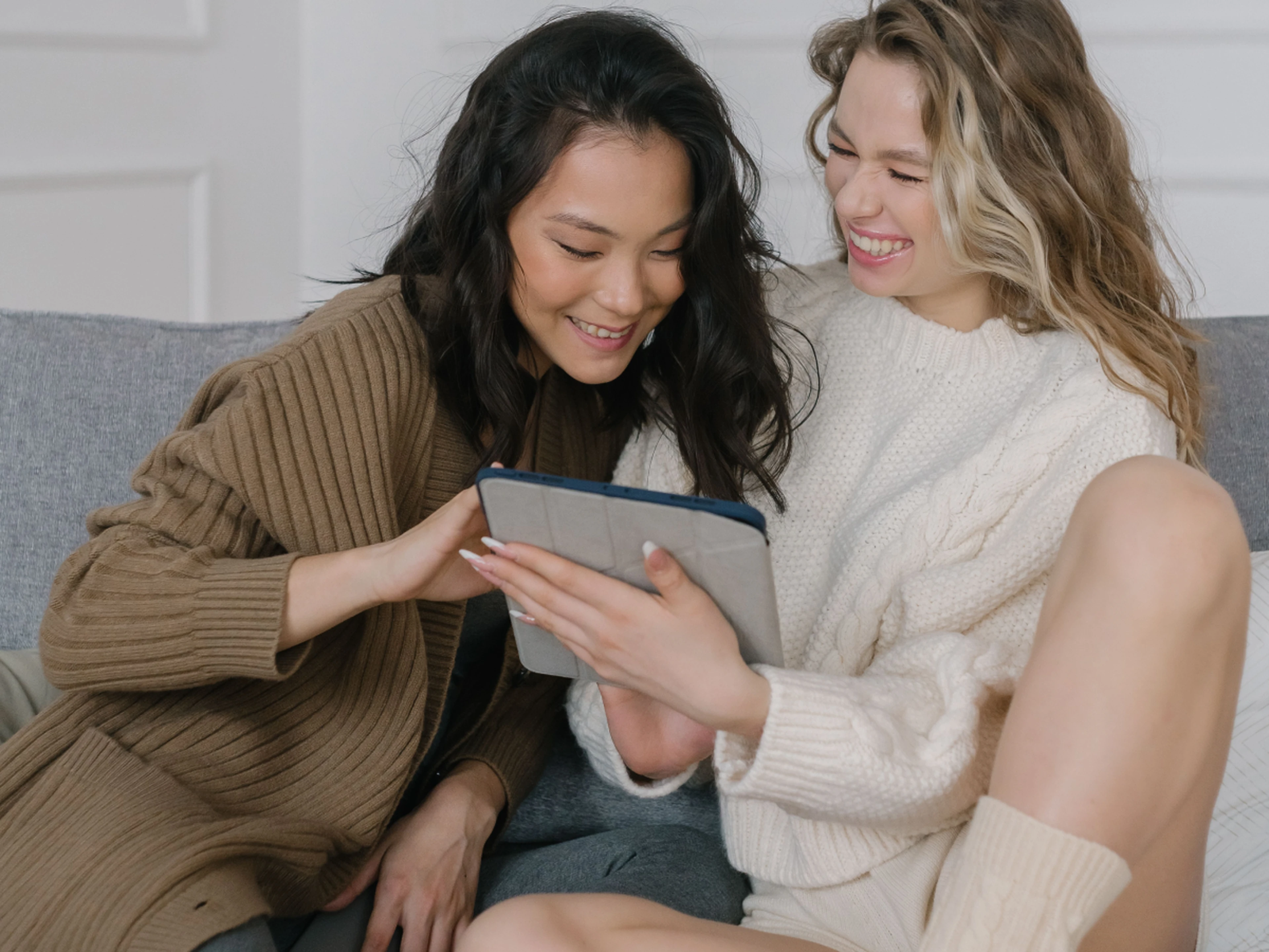 two women browsing deals on a tablet