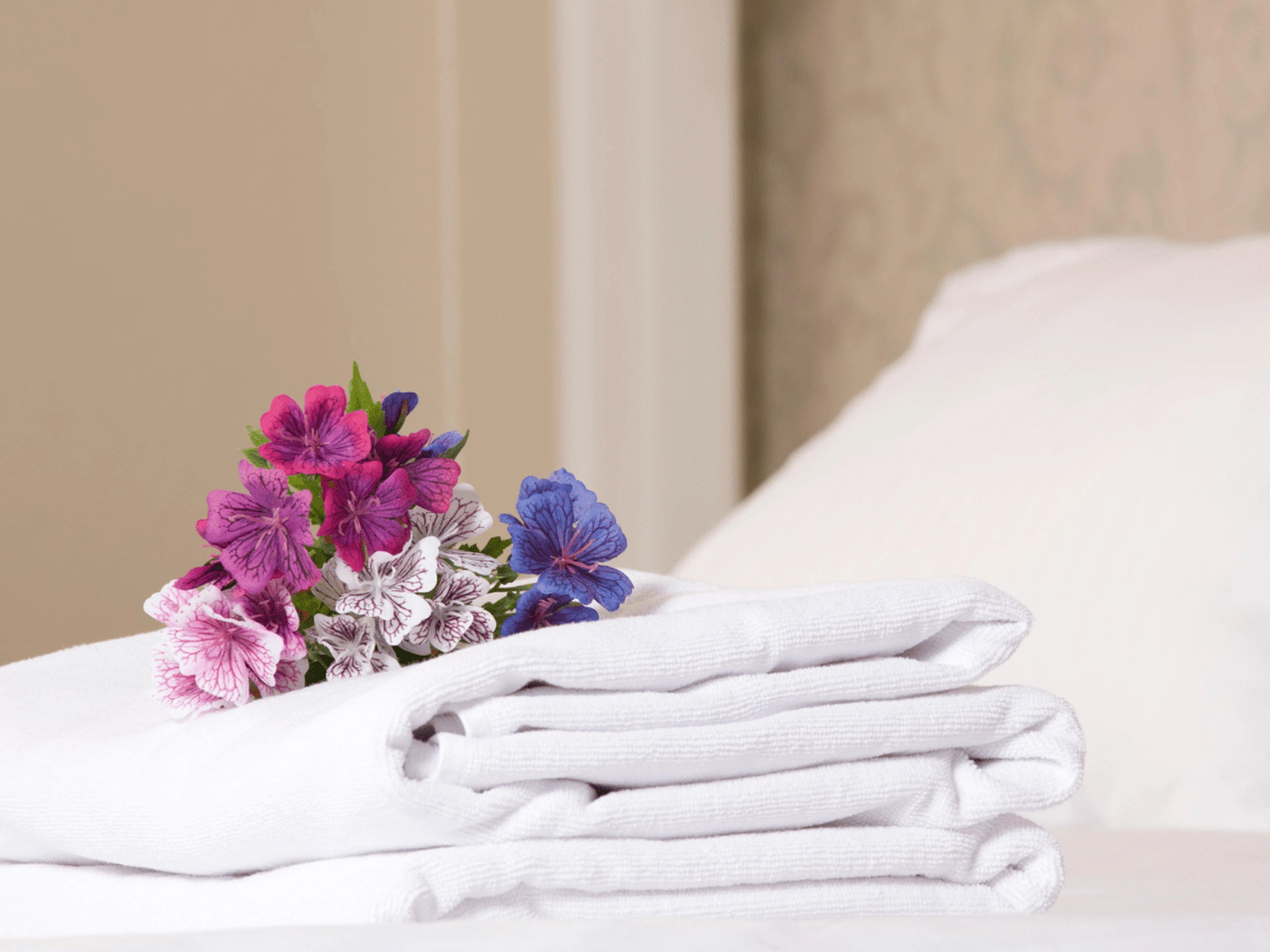 neatly folded towels on a hotel bed