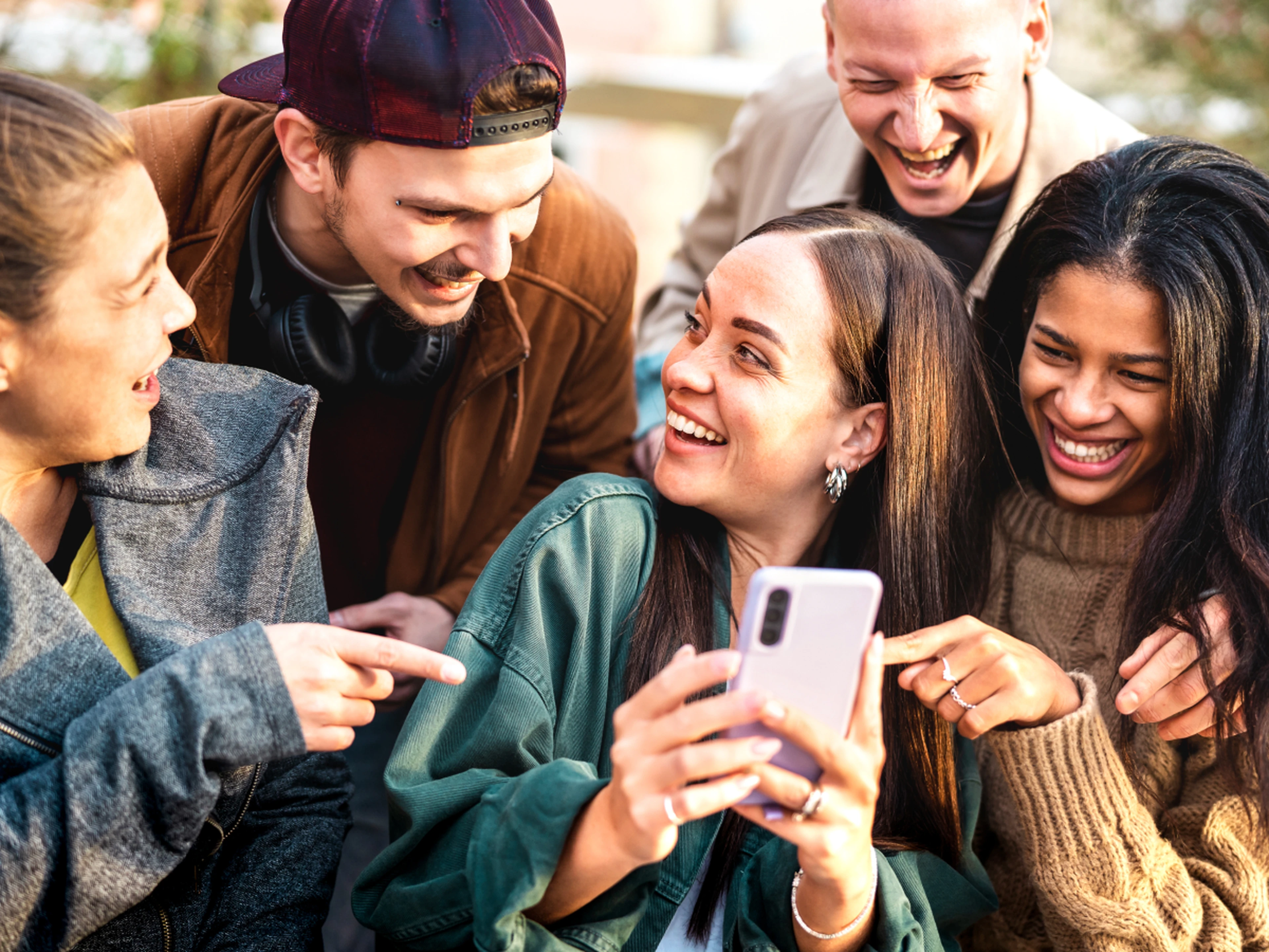 Group of young people looking at a phone