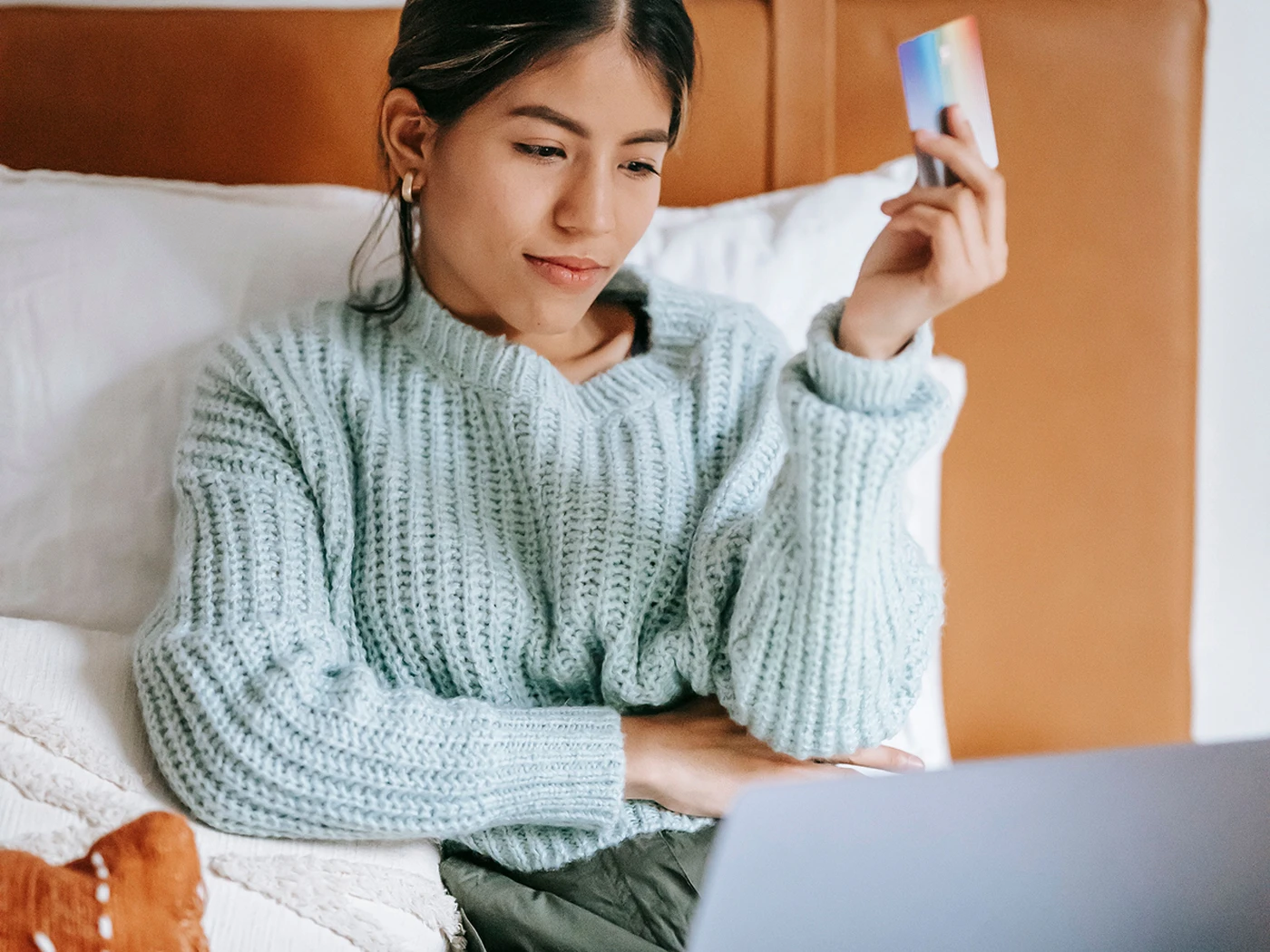 consumer holding a credit card, ready to book a hotel