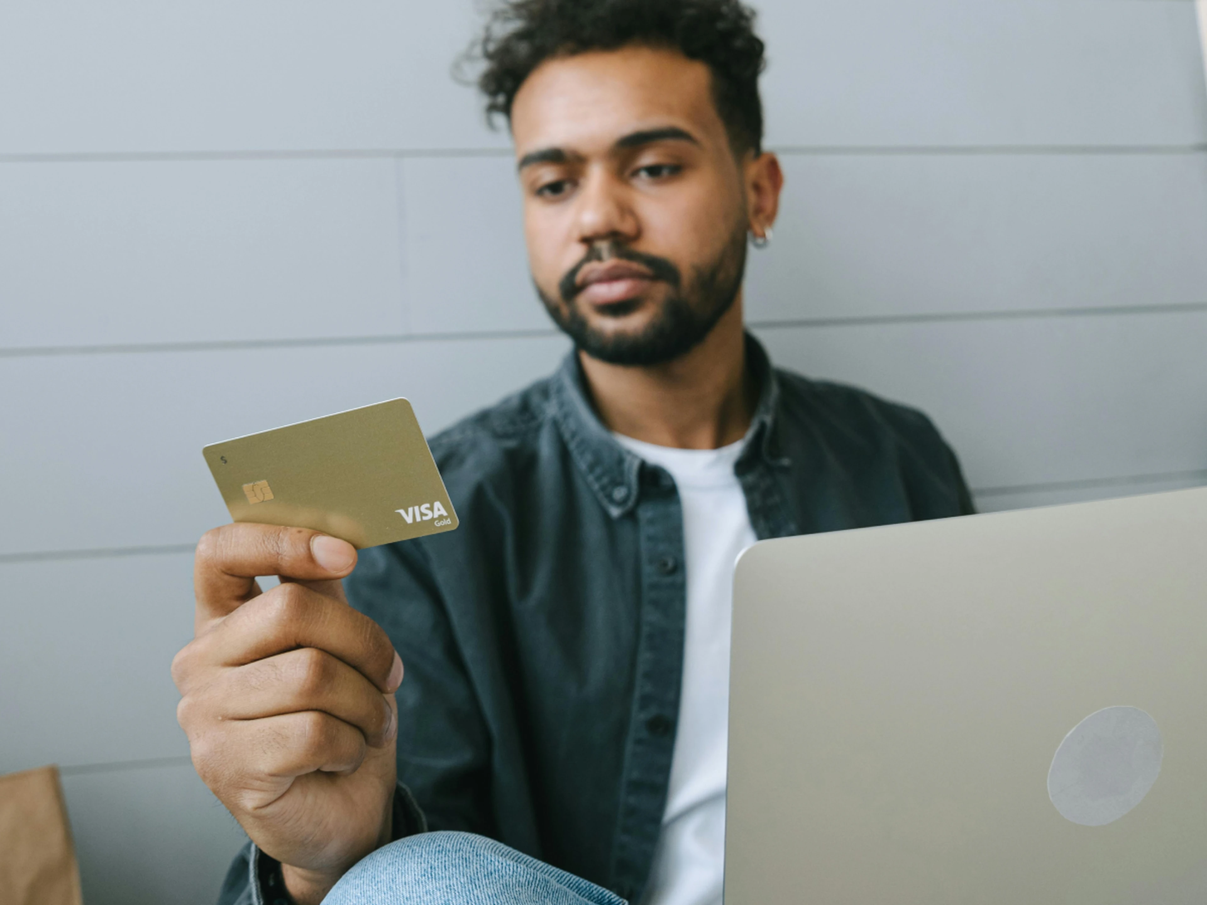 customer with laptop using a credit card
