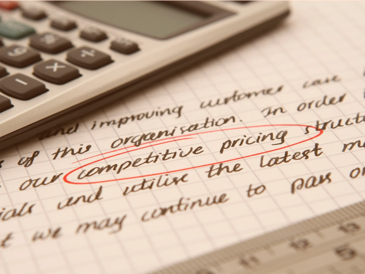 calculator on top of paper notes with the words competitive pricing circled in red
