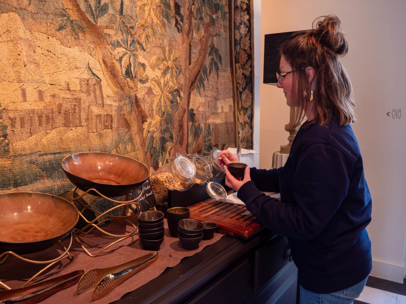 Woman taking breakfast in a hotel at the buffet