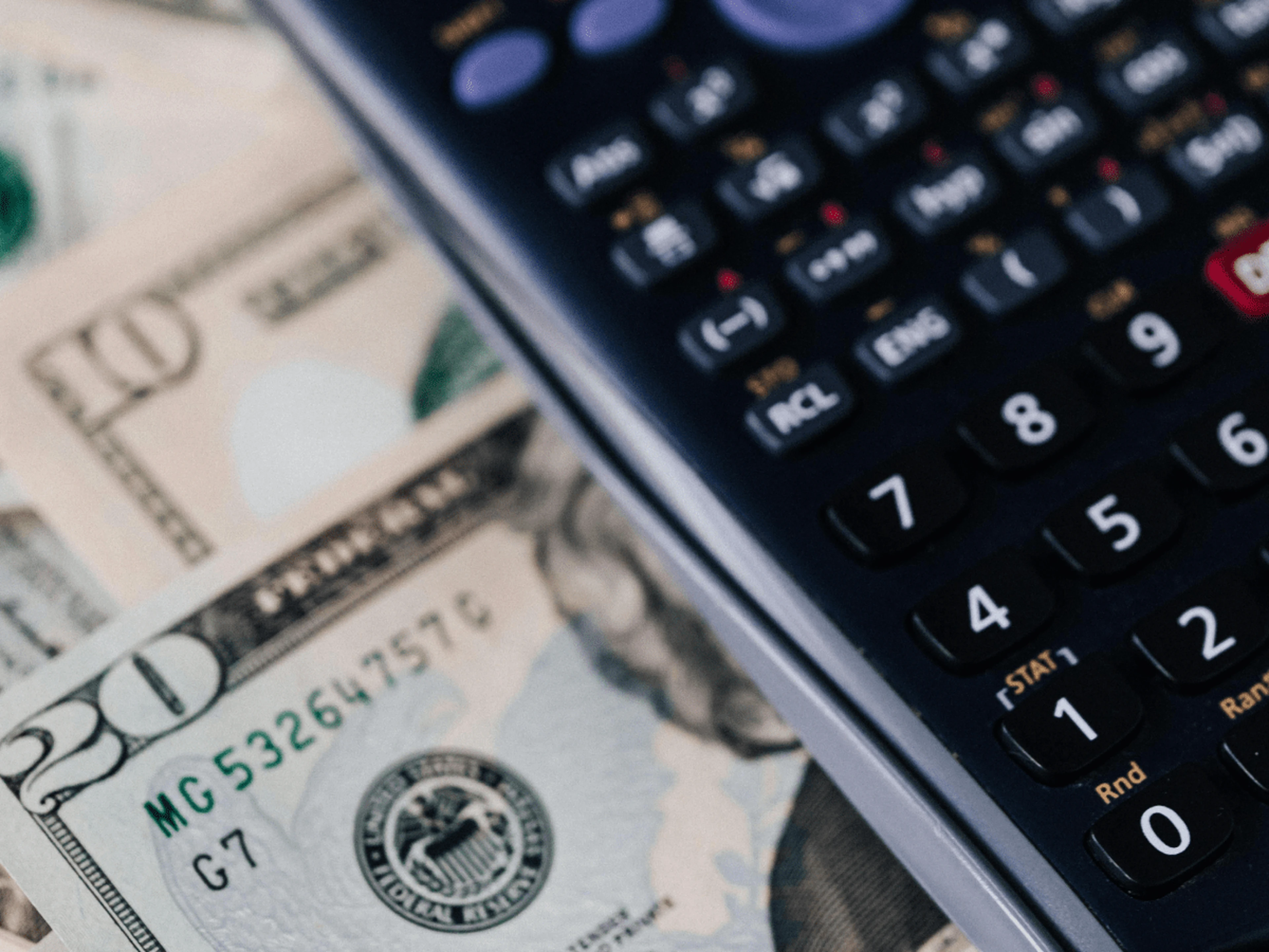 dollar bills and a calculator
