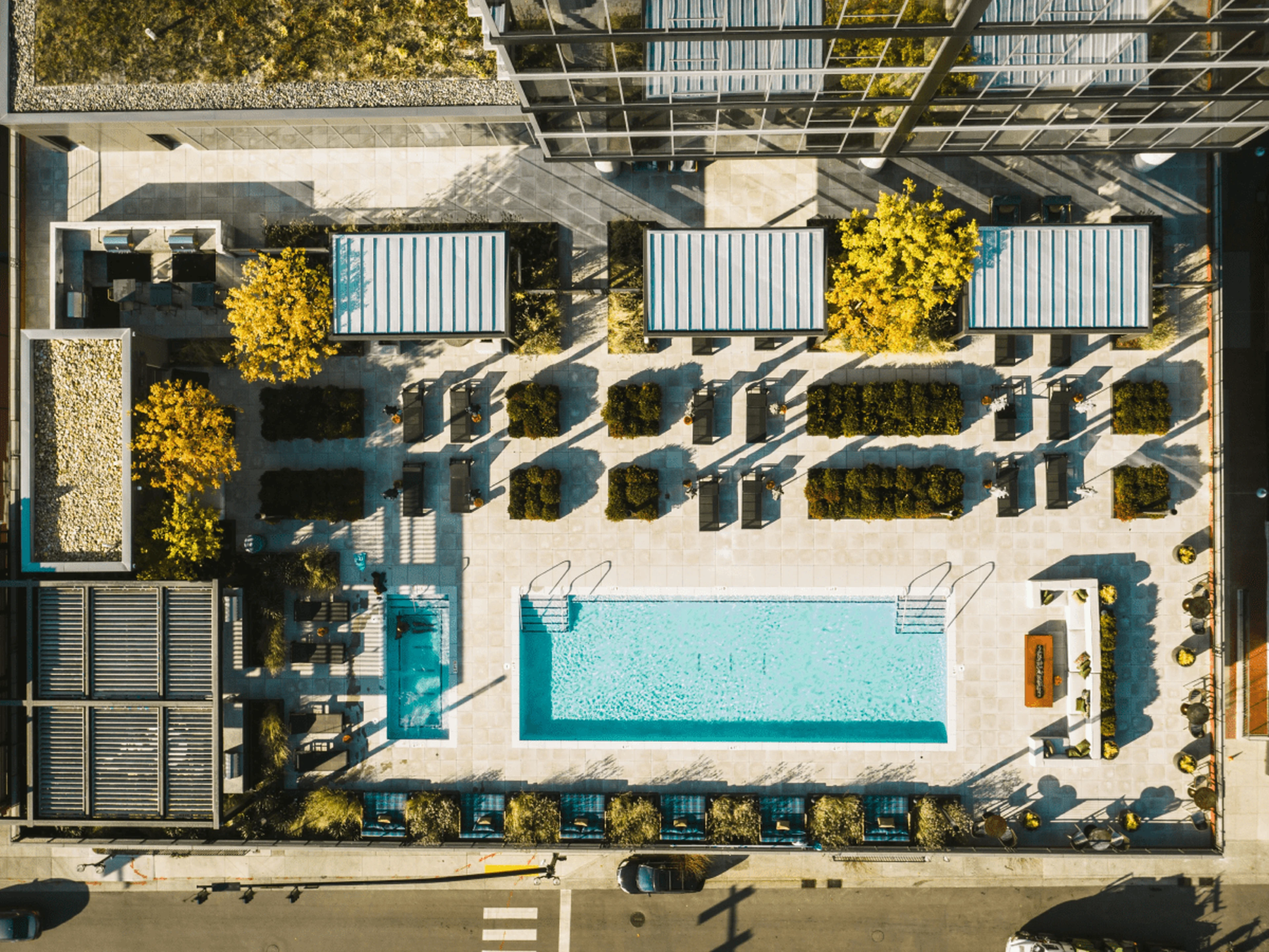 Top view of a hotel with two pools and outdoor seating
