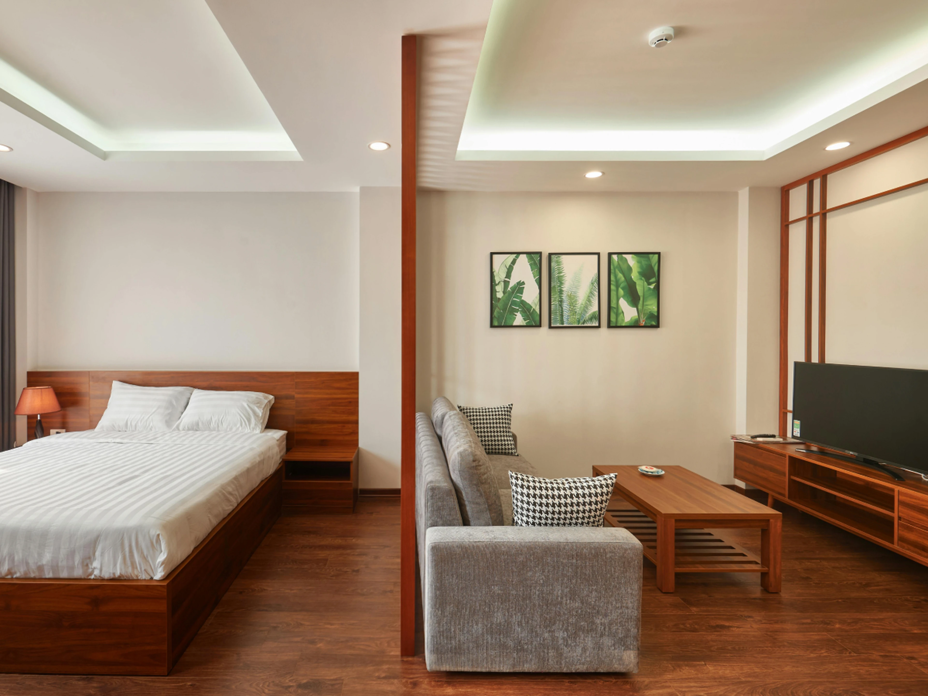 hotel room suite with large seating area and TV