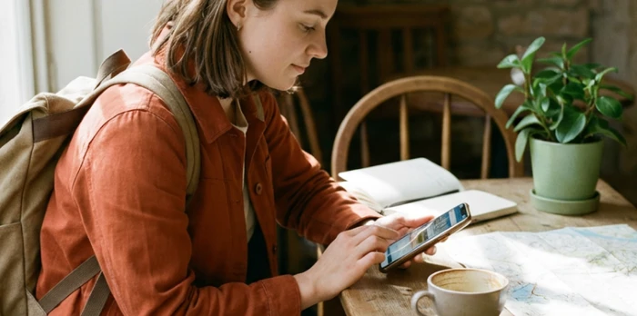 Young traveler booking a nearby hotel on their smartphone