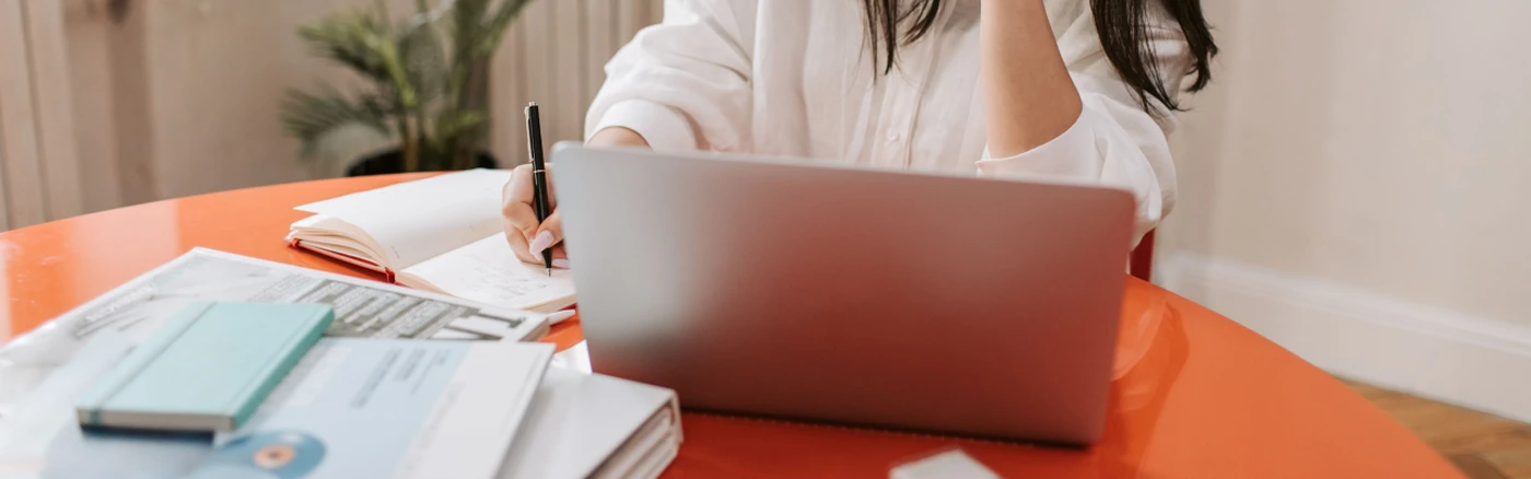 hotel owner working on a laptop and taking notes