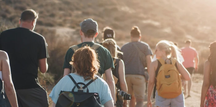 Group of people walking in a mountain area in the sun