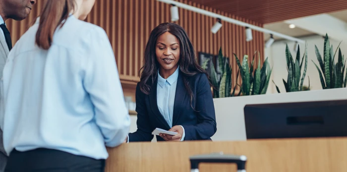 Two persons checking in to a hotel