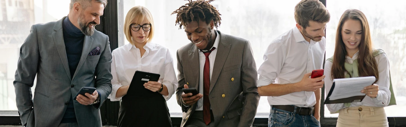 Five independent hoteliers smiling and sharing insights