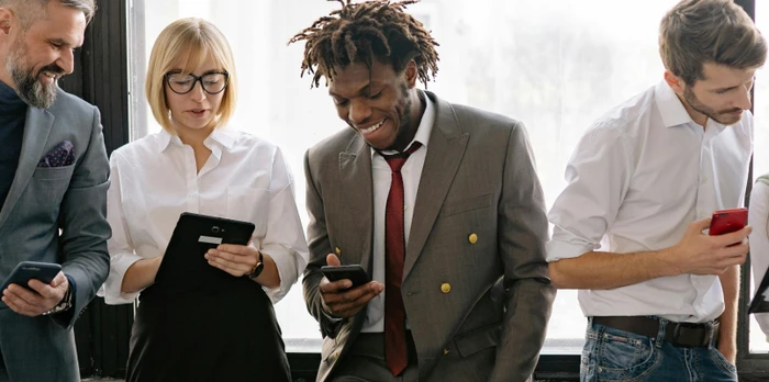 Five independent hoteliers smiling and sharing insights