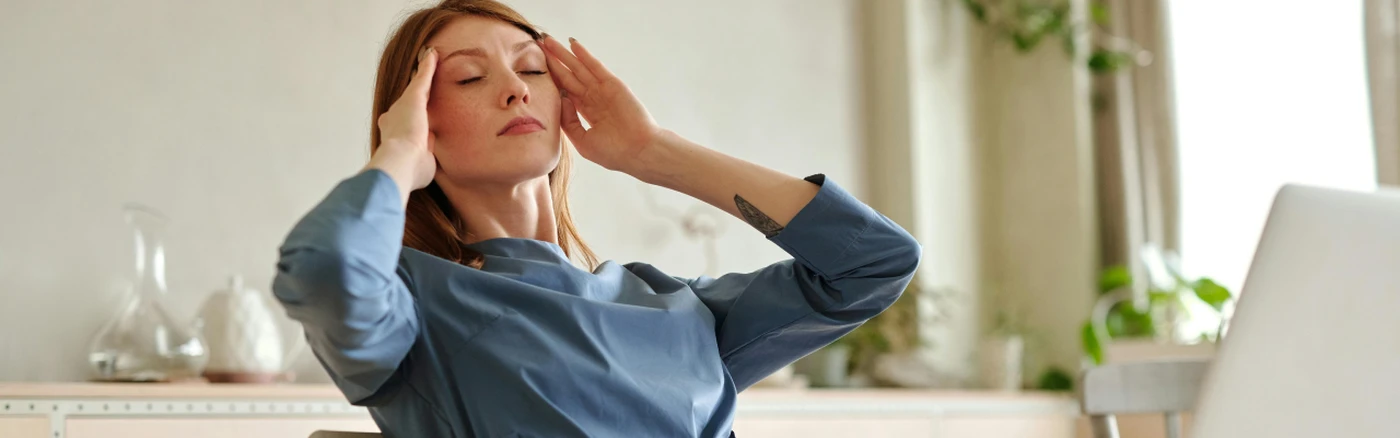 hotel owner sitting at a desk with a laptop, trying to stay calm