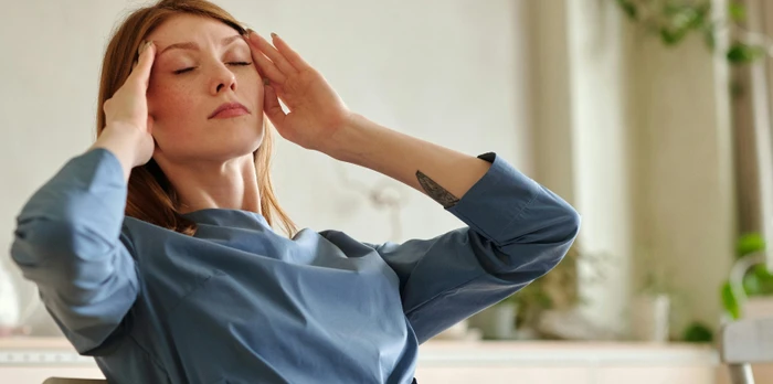 hotel owner sitting at a desk with a laptop, trying to stay calm