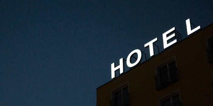 Hotel sign on top of a building during the night
