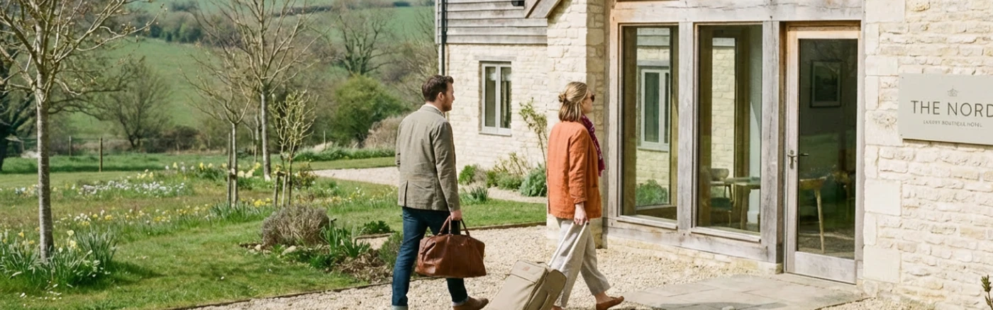 two travelers approaching a boutique hotel in the countryside